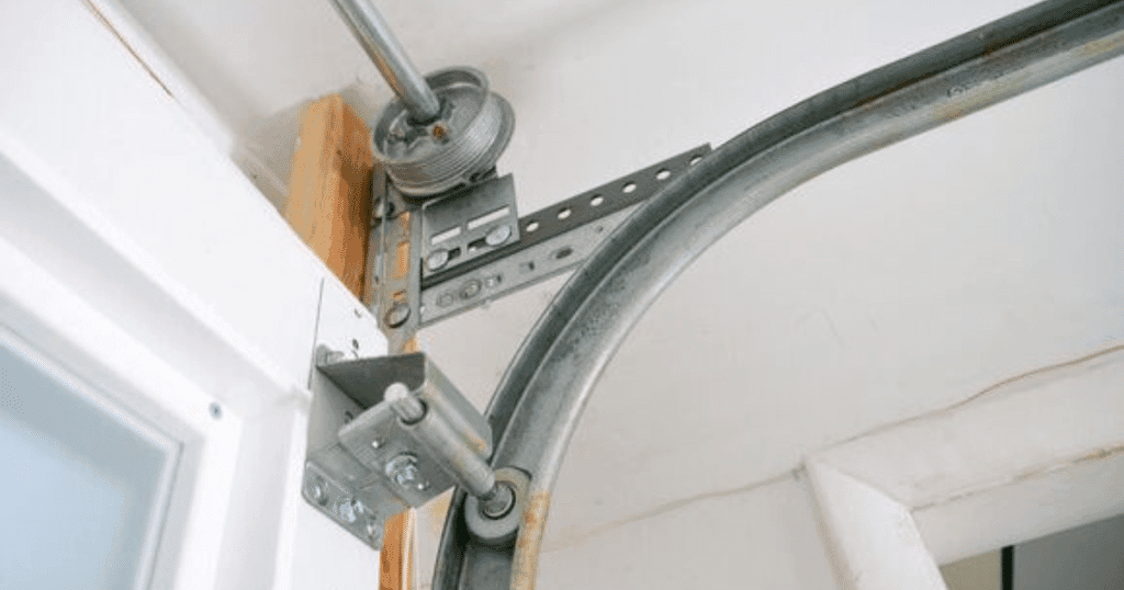 Close-up of a garage door track and pulley system.