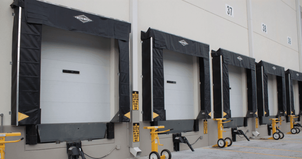 "Warehouse docks with closed freight loading doors."